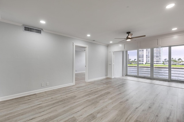 empty room featuring ornamental molding, recessed lighting, visible vents, and light wood-style floors