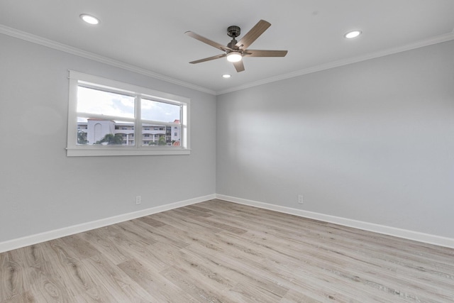 unfurnished room with baseboards, wood finished floors, and crown molding