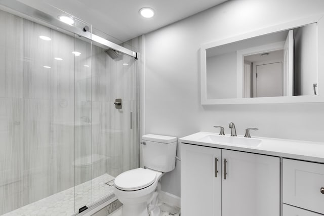 bathroom with marble finish floor, a shower stall, toilet, and vanity