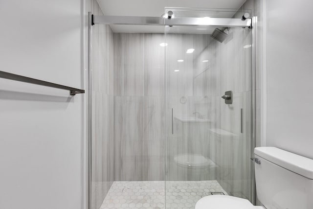 full bath featuring a shower stall and toilet