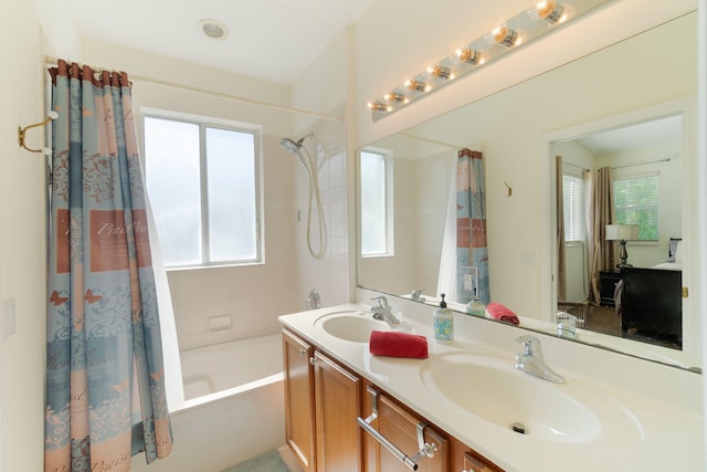 bathroom with shower / bath combination with curtain, a healthy amount of sunlight, and a sink