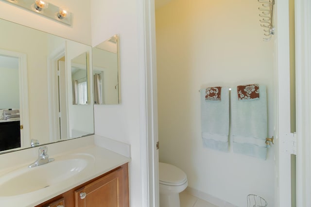 bathroom with tile patterned flooring, toilet, and vanity