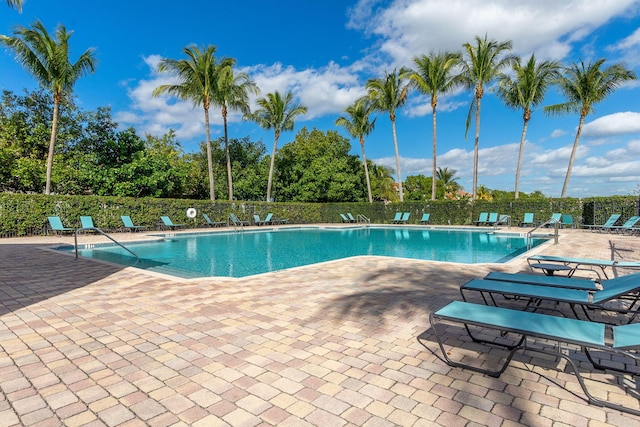 community pool featuring a patio area and fence