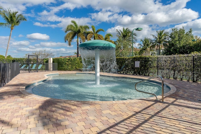 view of swimming pool featuring fence