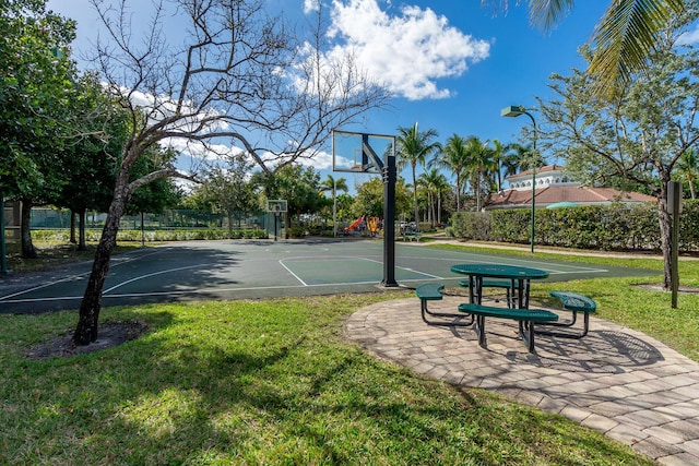 view of basketball court with community basketball court, a yard, and fence