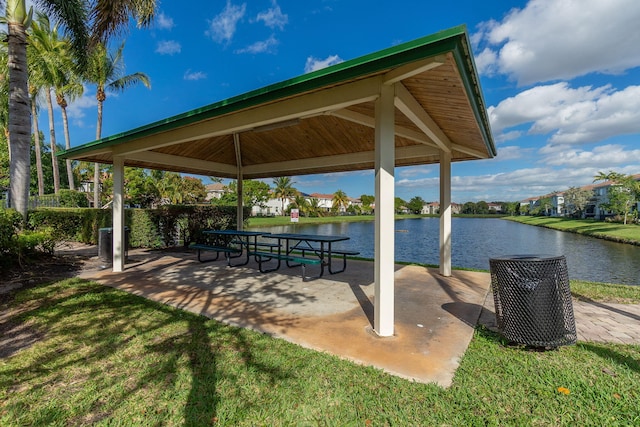 exterior space featuring a gazebo, a patio, a yard, and a water view