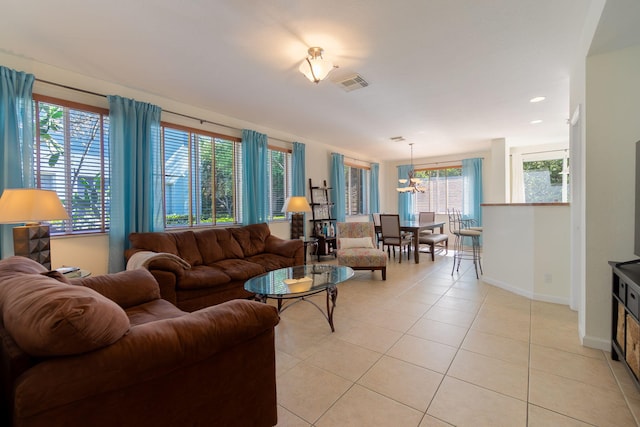 living area with light tile patterned floors, visible vents, and baseboards