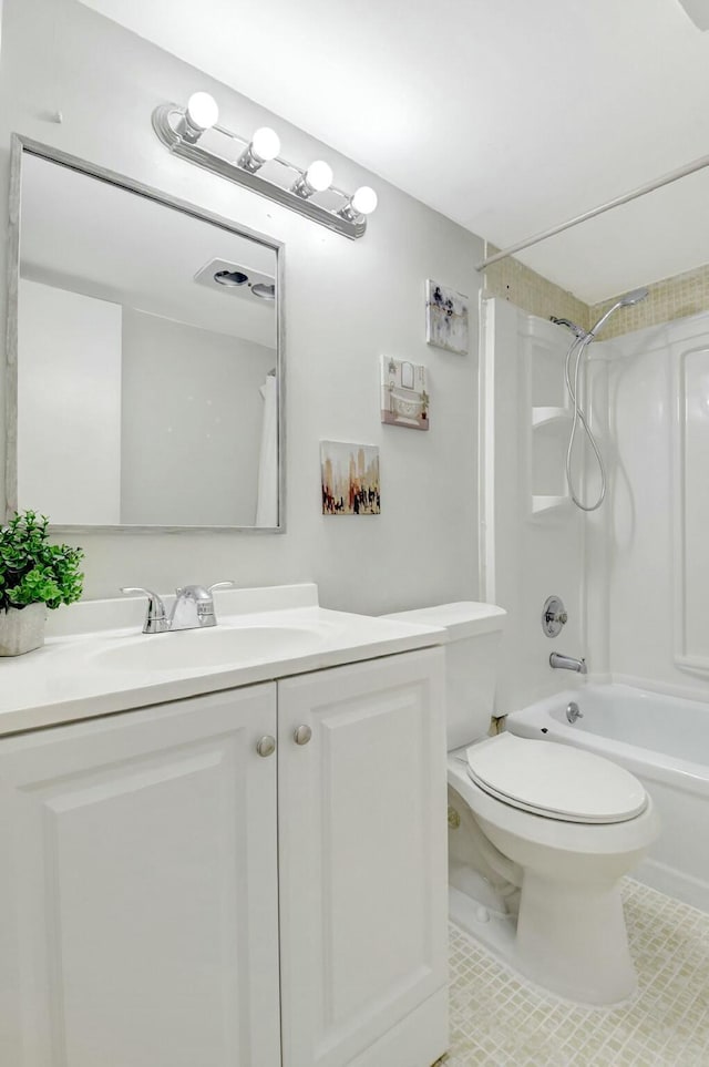 bathroom featuring shower / washtub combination, vanity, toilet, and tile patterned floors