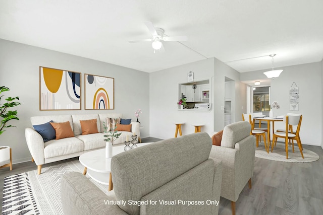 living room featuring wood finished floors and a ceiling fan