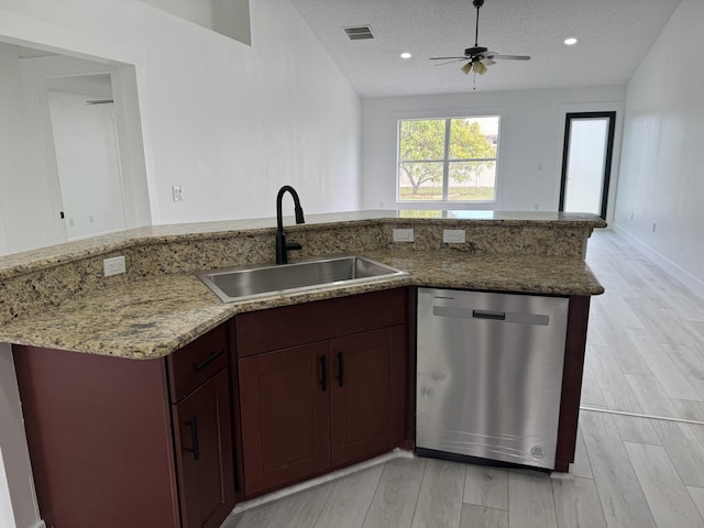 kitchen with visible vents, dishwasher, light stone counters, a textured ceiling, and a sink