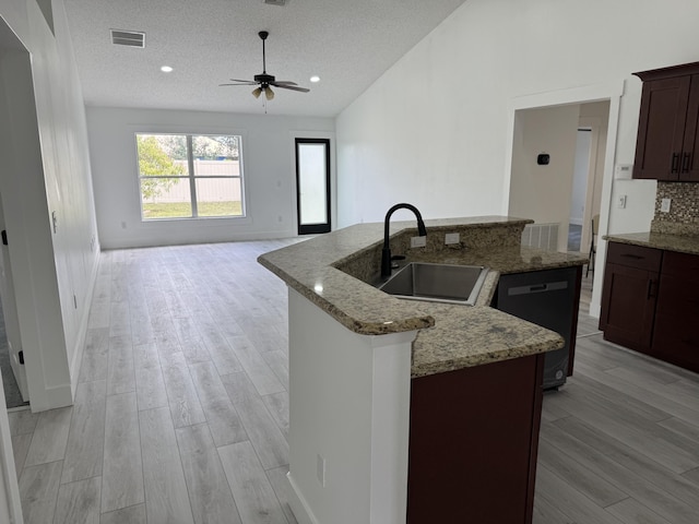 kitchen with dishwasher, visible vents, a sink, and light wood-style flooring