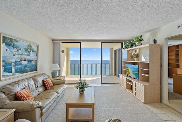 living room featuring tile patterned flooring, floor to ceiling windows, and a textured ceiling