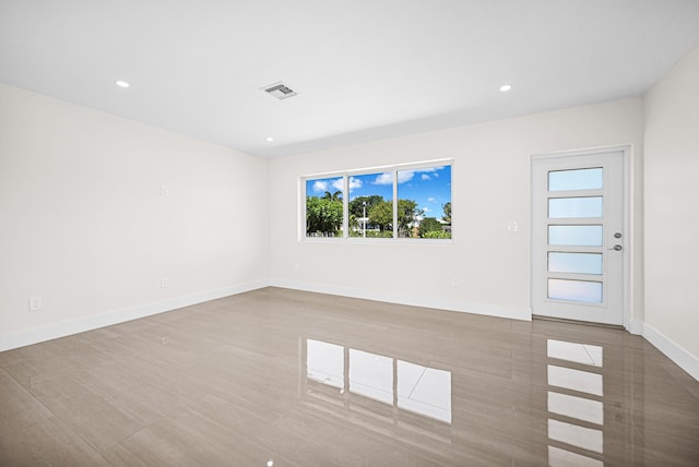 unfurnished room featuring recessed lighting, baseboards, and visible vents