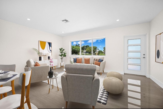 living room with recessed lighting, visible vents, and baseboards