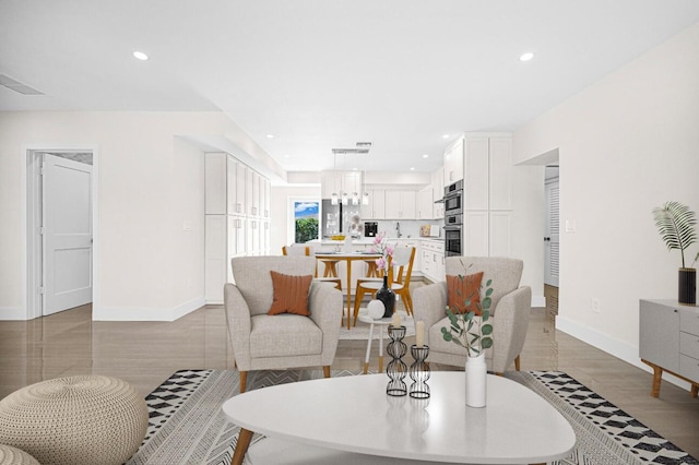 living room with recessed lighting, visible vents, and baseboards