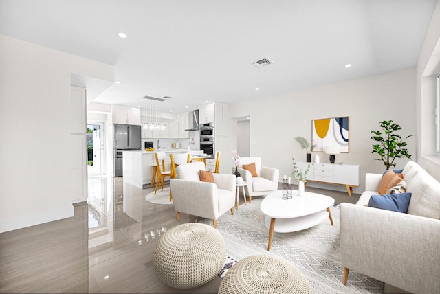 living area featuring visible vents, recessed lighting, and baseboards