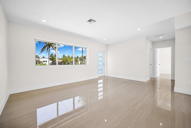 empty room with recessed lighting, baseboards, and visible vents