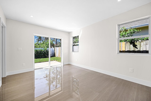 empty room with recessed lighting and baseboards