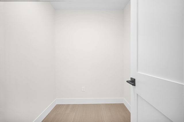 spare room featuring light wood-style flooring and baseboards