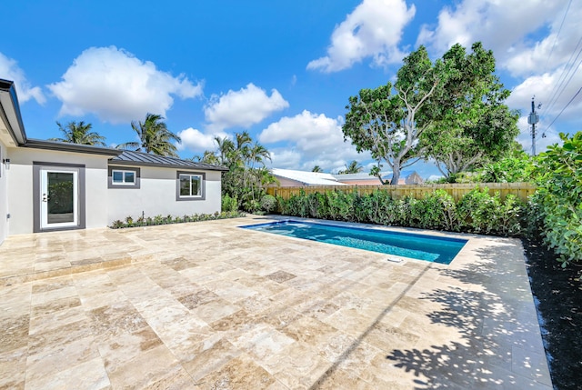 view of swimming pool featuring a fenced in pool, a fenced backyard, and a patio area