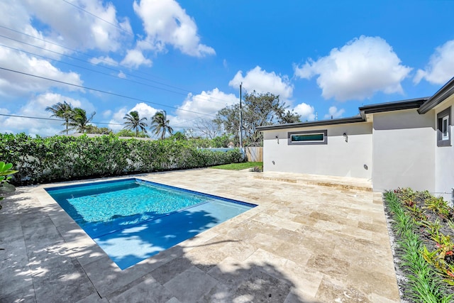 view of swimming pool featuring a fenced in pool, a patio, and fence