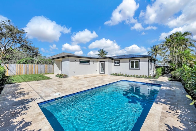 back of house with metal roof, a fenced backyard, and a patio area