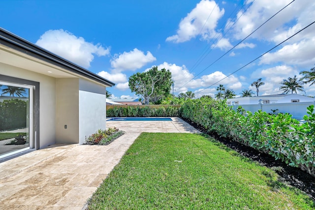 view of yard featuring a patio area, a fenced in pool, and fence