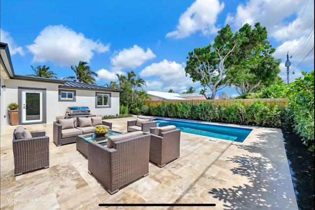 view of pool featuring a patio, a fenced in pool, a fenced backyard, outdoor lounge area, and a grill