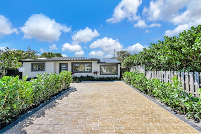 view of front of home featuring fence