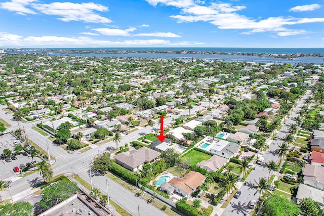 drone / aerial view with a residential view and a water view