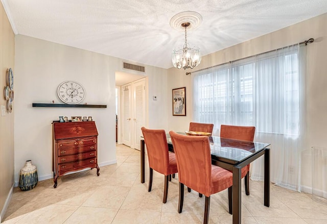 dining room with visible vents, light tile patterned flooring, a textured ceiling, a chandelier, and baseboards