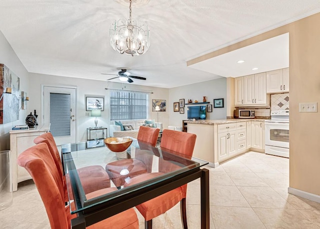 dining room featuring light tile patterned flooring and ceiling fan with notable chandelier