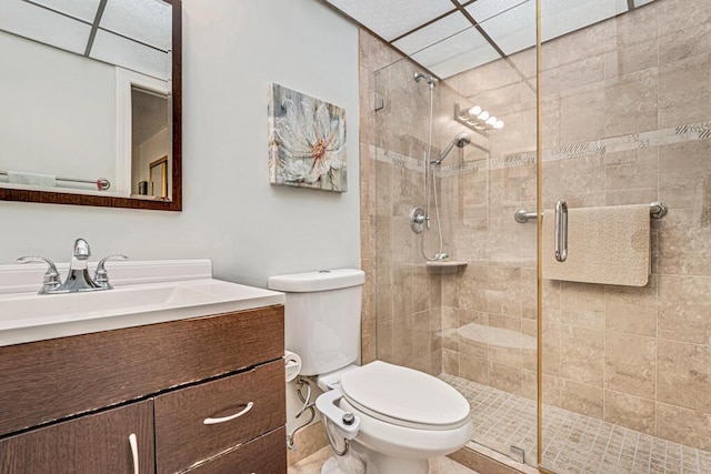 full bathroom featuring vanity, a shower stall, and toilet