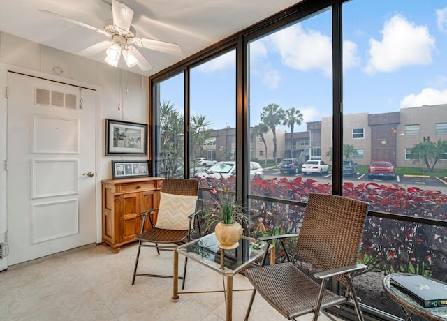 sunroom featuring ceiling fan and visible vents