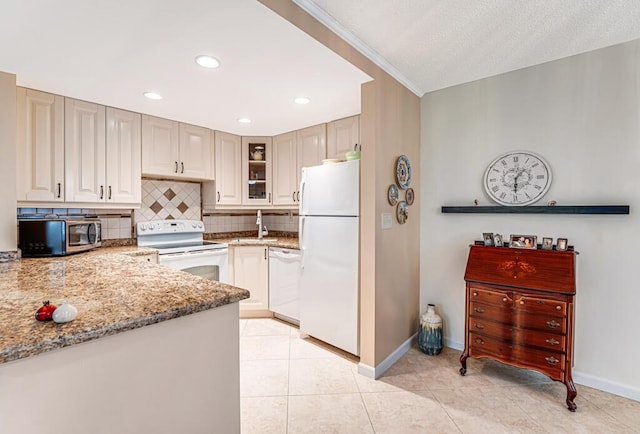 kitchen featuring white appliances, decorative backsplash, glass insert cabinets, light stone countertops, and light tile patterned flooring