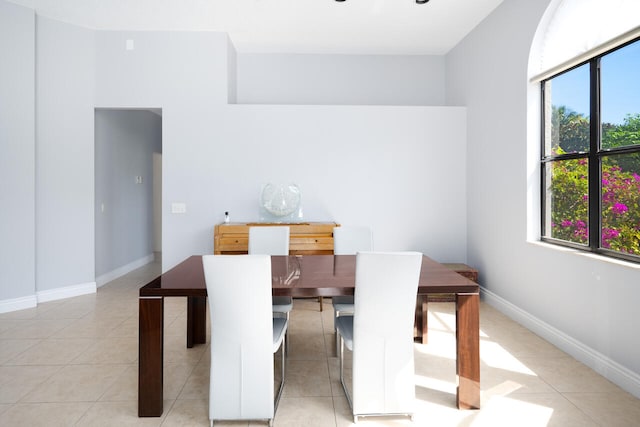 dining room featuring baseboards and light tile patterned flooring