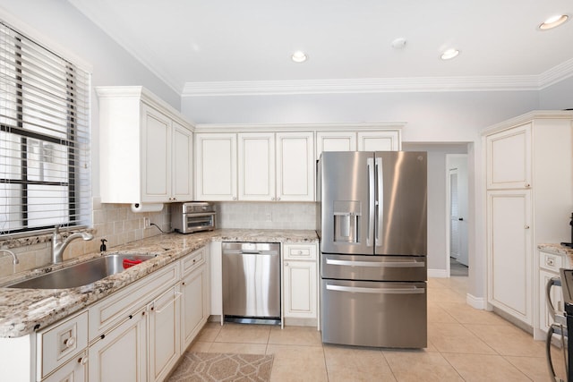 kitchen featuring stainless steel appliances, ornamental molding, light tile patterned flooring, and a sink