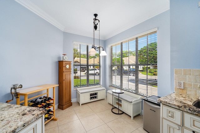 dining area featuring crown molding and light tile patterned flooring