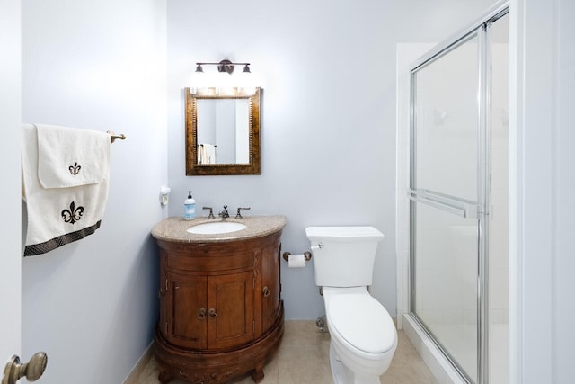 full bathroom featuring toilet, a stall shower, and vanity