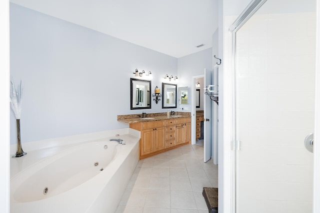 full bath with a whirlpool tub, tile patterned flooring, a sink, and a shower stall