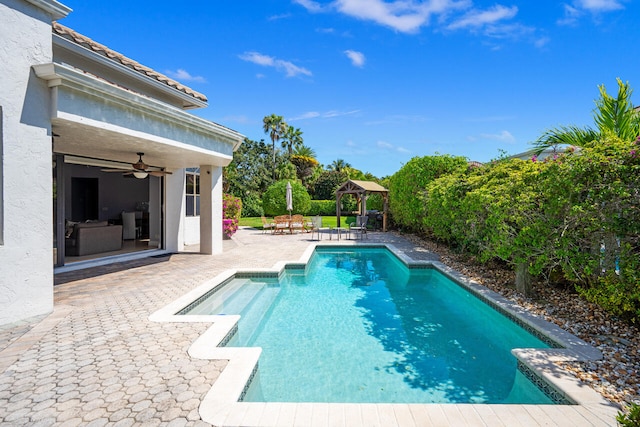 outdoor pool with ceiling fan, a patio, and a gazebo