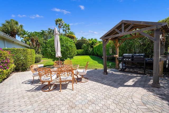 view of patio with a gazebo and outdoor dining space