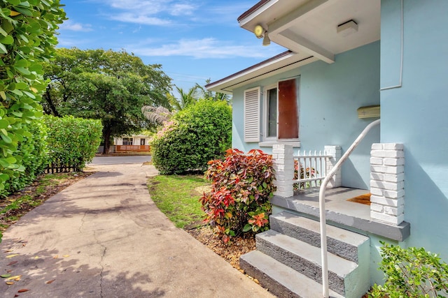 doorway to property featuring stucco siding