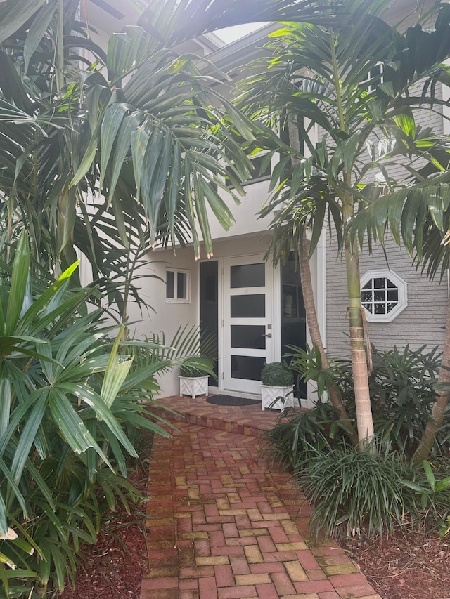 doorway to property featuring brick siding