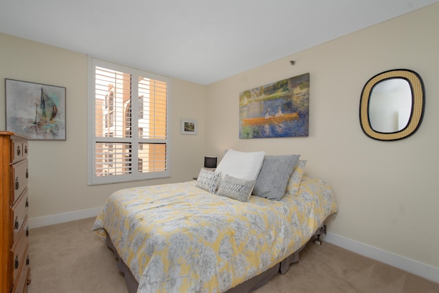 bedroom featuring carpet floors and baseboards