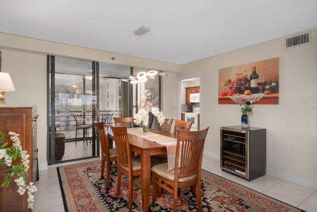 dining room featuring wine cooler, light tile patterned flooring, visible vents, and baseboards