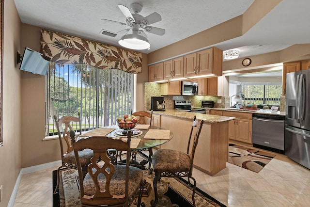 dining space with visible vents, a textured ceiling, light tile patterned floors, baseboards, and ceiling fan