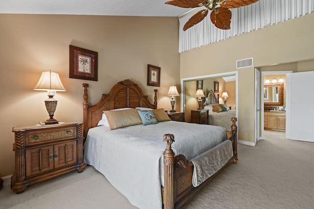 bedroom featuring visible vents, a ceiling fan, connected bathroom, carpet, and baseboards