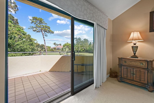 doorway featuring carpet and lofted ceiling