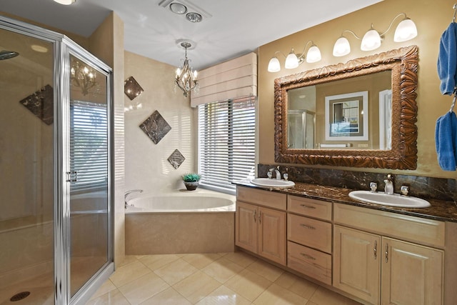 full bath with a stall shower, a sink, tile patterned flooring, double vanity, and a bath